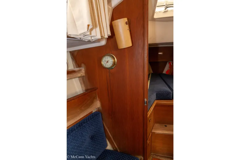 Slide: The Image of 1984 Sabre 32 Aft-Cabin interior with wood paneling and blue seating. - 48