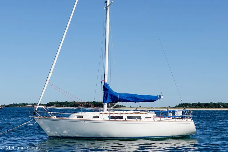 Slide: The Image of 1984 Sabre 32 Aft-Cabin sailboat on calm blue water under clear sky. - 54