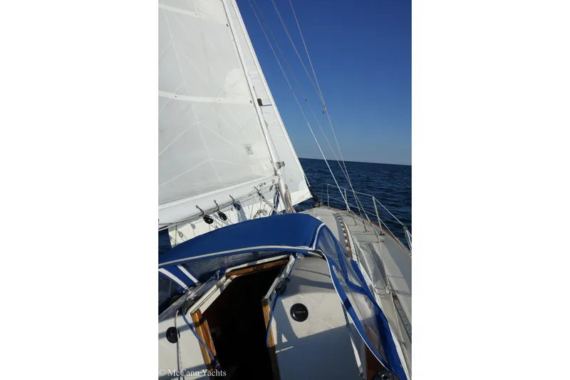 Slide: The Image of 1984 Sabre 32 Aft-Cabin sailboat on open sea with blue sky. - 22