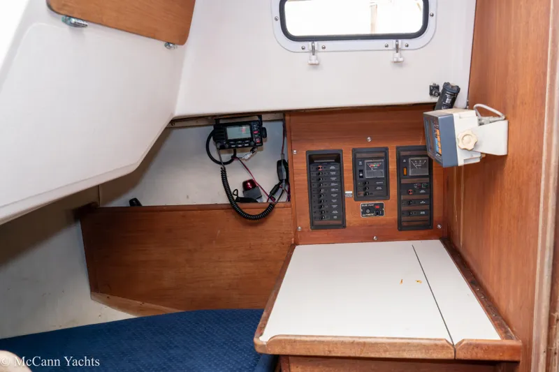 Slide: The Image of 1984 Sabre 32 Aft-Cabin interior with control panels and navigation equipment. - 32