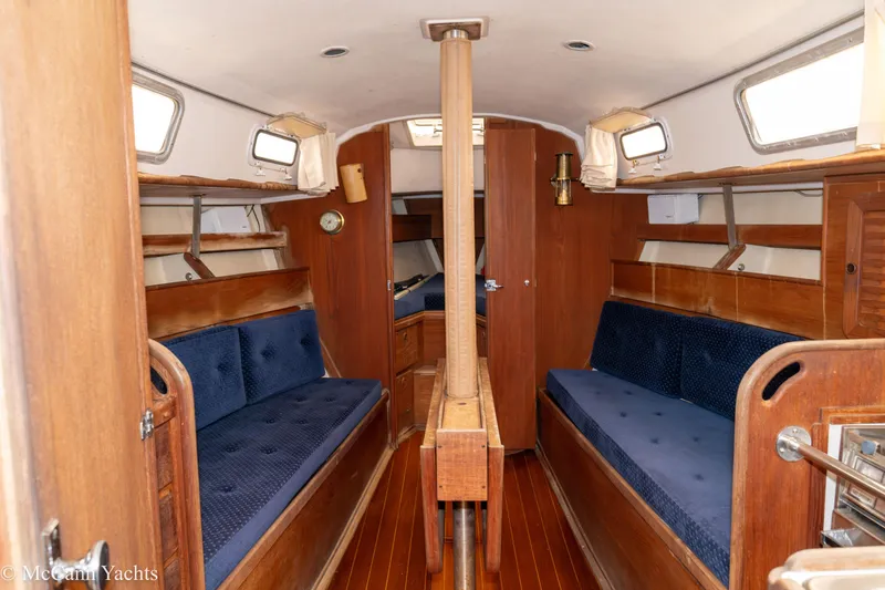 Slide: The Image of 1984 Sabre 32 Aft-Cabin interior with wooden finish and blue seating. - 44
