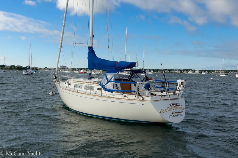 Slide: The Image of 1984 Sabre 32 Aft-Cabin sailboat anchored in a scenic harbor. - 5