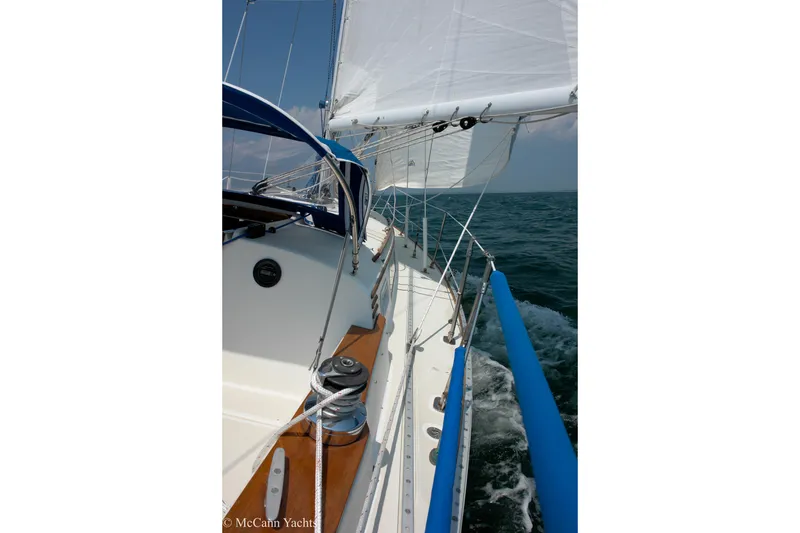 Slide: The Image of 1984 Sabre 32 Aft-Cabin sailboat navigating ocean waters under clear skies. - 9