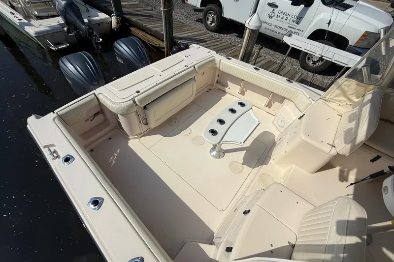 Slide: The Image of 2007 Grady-White Express 330 boat interior with seating and table, docked at marina. - 11