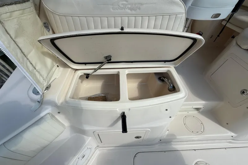 Slide: The Image of 2007 Grady-White Express 330 boat interior with open storage compartment. - 13