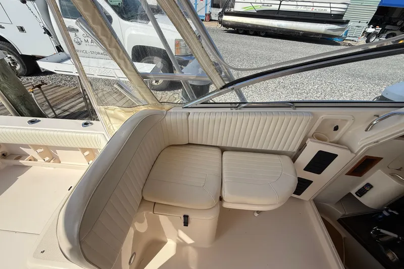 Slide: The Image of 2007 Grady-White Express 330 boat interior with beige seating and clear enclosure. - 17
