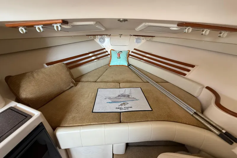 Slide: The Image of 2007 Grady-White Express 330 cabin interior with cozy seating and nautical decor. - 23