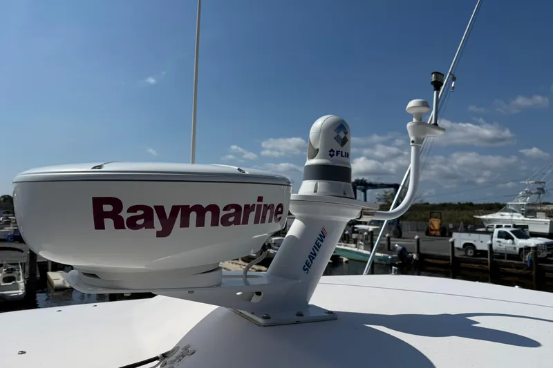 Slide: The Image of Radar and antenna equipment on a 2007 Grady-White Express 330 boat, featuring Raymarine and FLIR systems. - 29