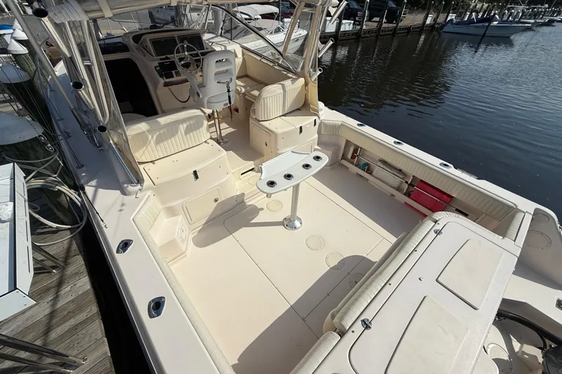 Slide: The Image of 2007 Grady-White Express 330 boat interior with seating and helm, docked by the water. - 5