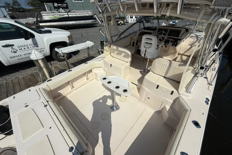 Slide: The Image of 2007 Grady-White Express 330 boat interior with seating and steering area at marina. - 6