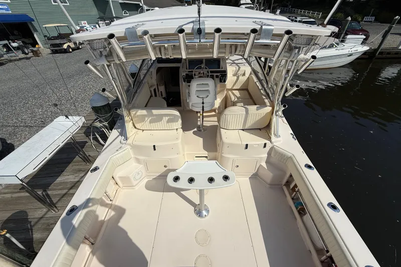 Slide: The Image of 2007 Grady-White Express 330 boat interior with seating and fishing rod holders. - 7