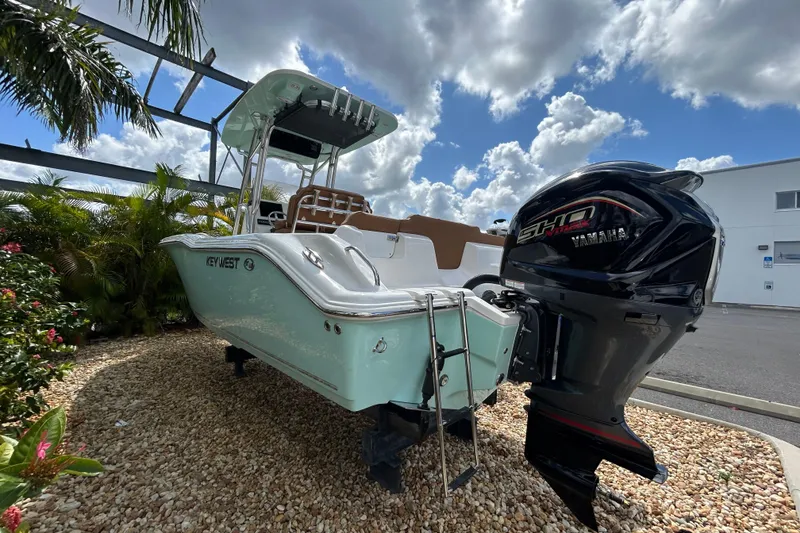 Slide: The Image of 2026 Key West 239 FS boat with Yamaha engine, displayed outdoors under a cloudy sky. - 4