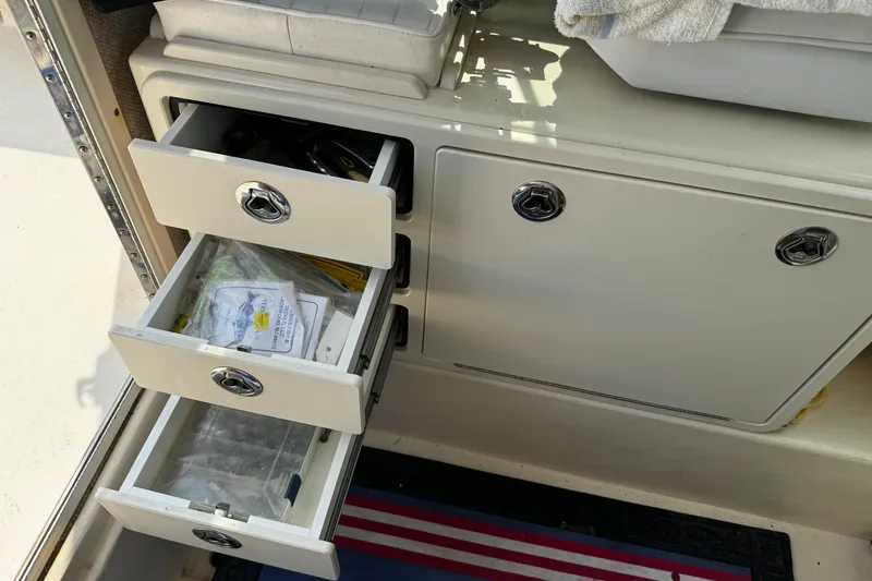 Slide: The Image of Interior storage drawers of a 2007 Parker 2320 SL Sport Cabin boat. - 19