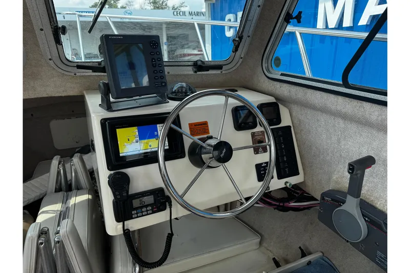 Slide: The Image of 2007 Parker 2320 SL Sport Cabin boat interior with steering wheel and navigation equipment. - 21