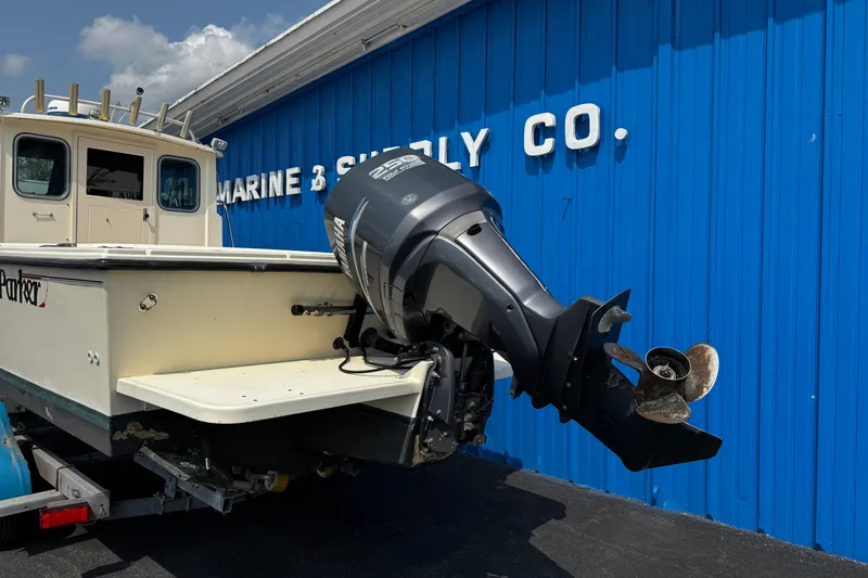 Slide: The Image of 2007 Parker 2320 SL Sport Cabin boat with outboard motor at marine supply store. - 3