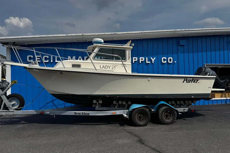 Slide: The Image of 2007 Parker 2320 SL Sport Cabin boat on trailer outside marine supply store. - 30