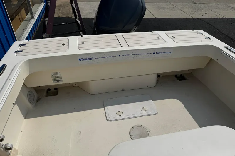 Slide: The Image of 2007 Parker 2320 SL Sport Cabin boat interior with storage compartments and TackleDirect branding. - 6