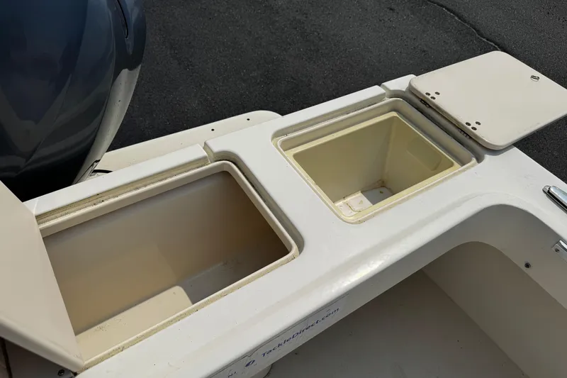 Slide: The Image of Open storage compartments on a 2007 Parker 2320 SL Sport Cabin boat deck. - 7