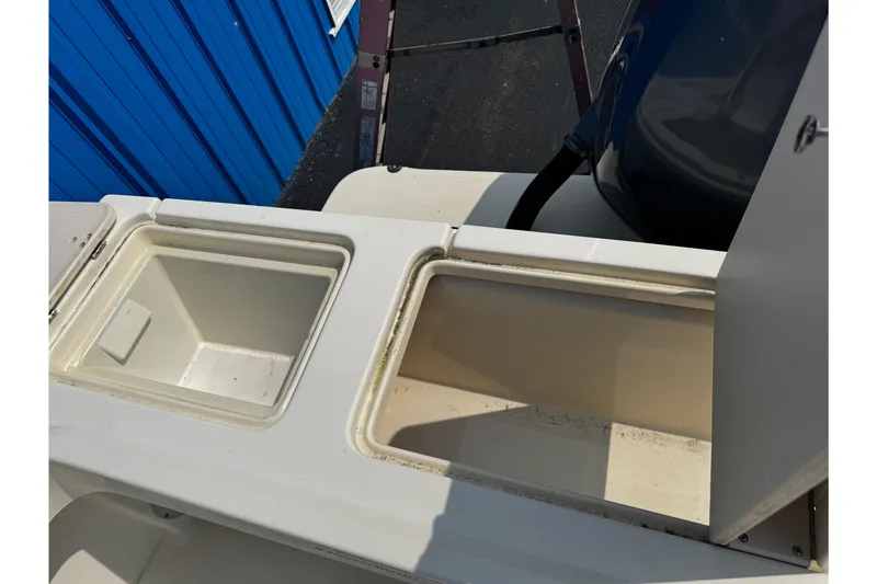 Slide: The Image of Open storage compartments on a 2007 Parker 2320 SL Sport Cabin boat. - 8