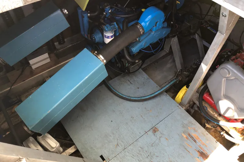 Slide: The Image of Engine compartment of a 1977 Pluckebaum Baymaster 52 boat, featuring blue engine components. - 10