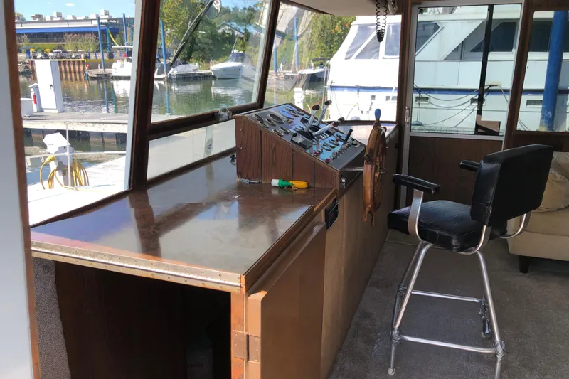 Slide: The Image of 1977 Pluckebaum Baymaster 52 helm with steering wheel, control panel, and captain's chair. - 14