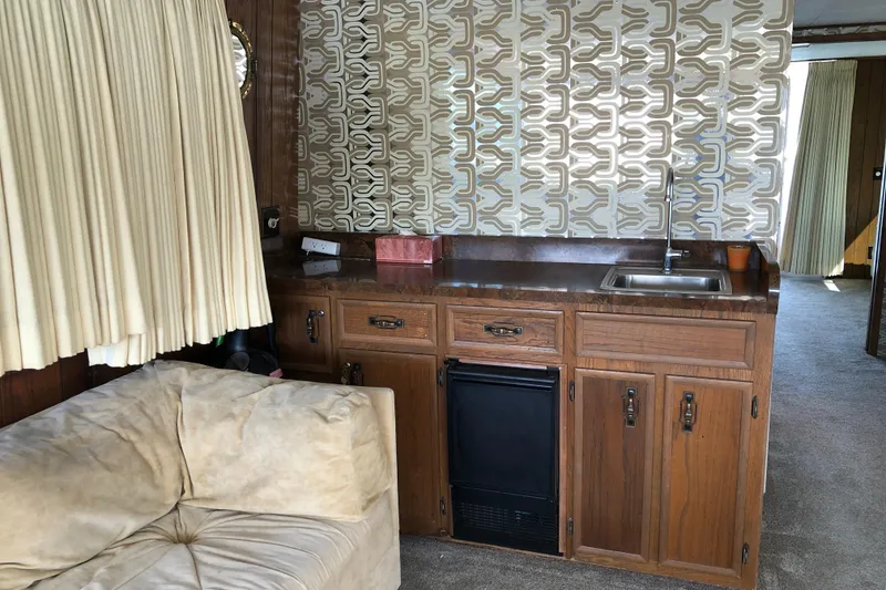 Slide: The Image of 1977 Pluckebaum Baymaster 52 interior with retro kitchen and patterned wallpaper. - 18