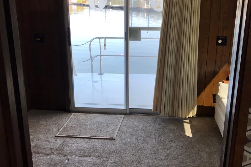 Slide: The Image of Interior view of 1977 Pluckebaum Baymaster 52 with sliding glass door and carpeted floor. - 23