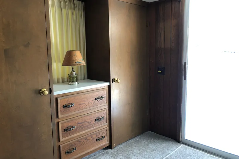 Slide: The Image of Interior of 1977 Pluckebaum Baymaster 52 with wooden cabinets and vintage lamp. - 25