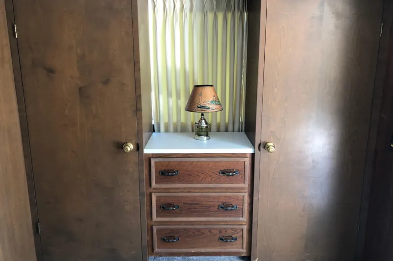 Slide: The Image of 1977 Pluckebaum Baymaster 52 interior with wooden drawers and vintage lamp. - 27