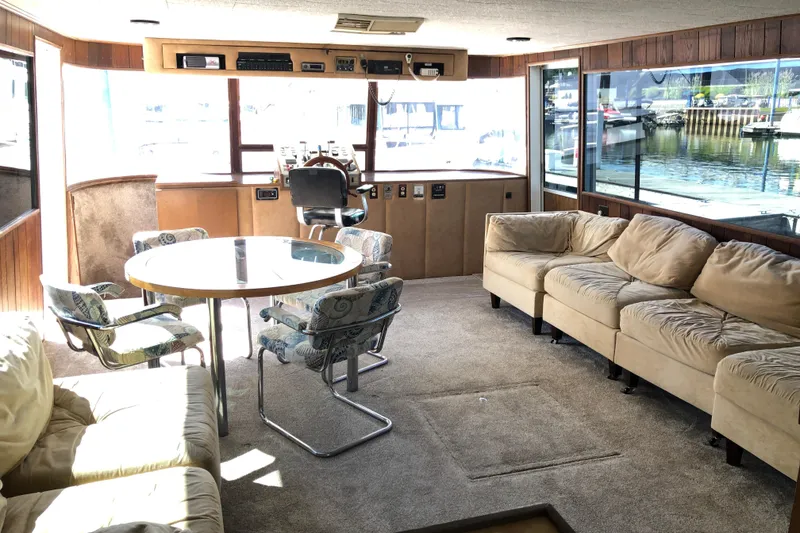 Slide: The Image of Interior of 1977 Pluckebaum Baymaster 52 yacht with sofas and round table. - 28
