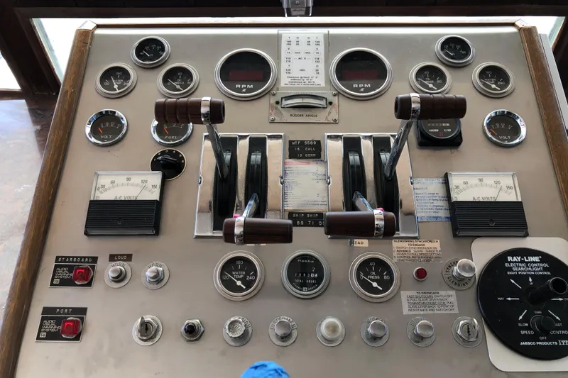 Slide: The Image of Control panel of a 1977 Pluckebaum Baymaster 52 boat with gauges and levers. - 29