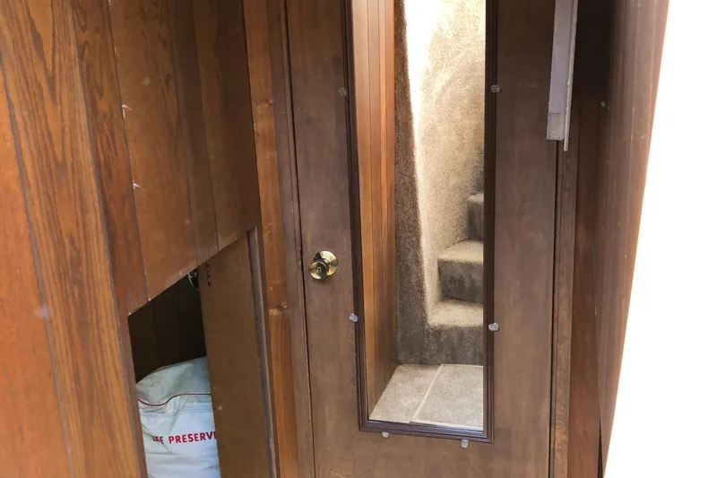 Slide: The Image of Interior of 1977 Pluckebaum Baymaster 52 with wooden paneling and carpeted stairs. - 31