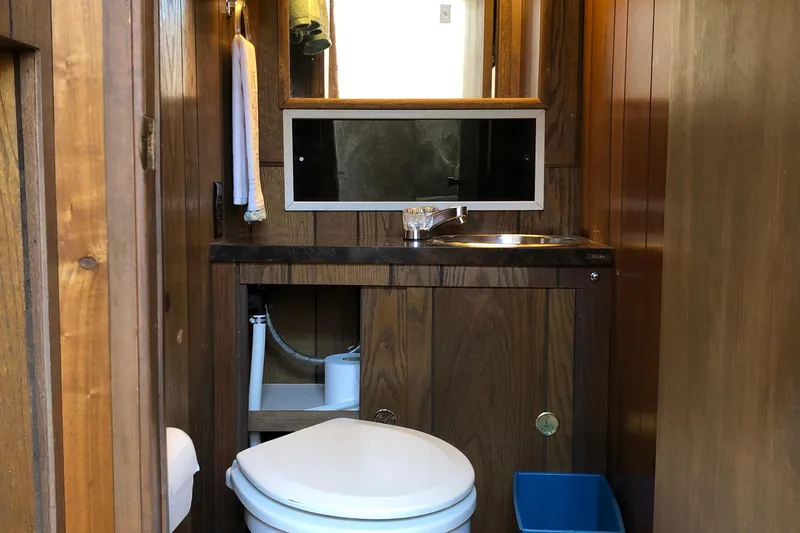 Slide: The Image of Wood-paneled bathroom in 1977 Pluckebaum Baymaster 52 yacht with sink and toilet. - 32