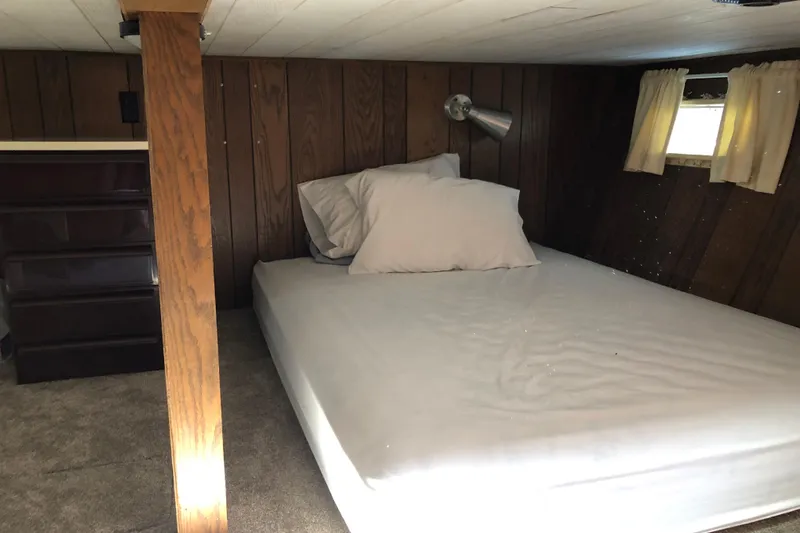Slide: The Image of Cozy bedroom in 1977 Pluckebaum Baymaster 52 with wood paneling and small window. - 36