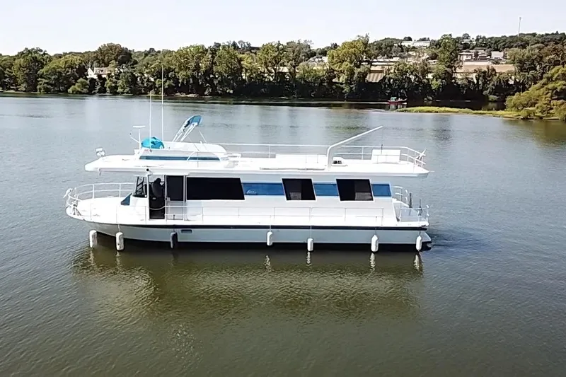 Slide: The Image of 1977 Pluckebaum Baymaster 52 X 17 Walkaround Sport Cruiser on a serene lake. - 40