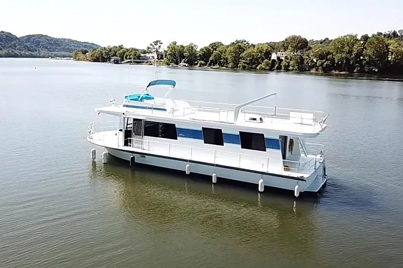 Slide: The Image of 1977 Pluckebaum Baymaster 52 X 17 Sport Cruiser on serene lake with lush shoreline. - 41