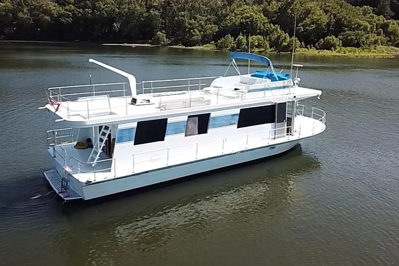 Slide: The Image of 1977 Pluckebaum Baymaster 52 X 17 Walkaround Sport Cruiser on calm water. - 44