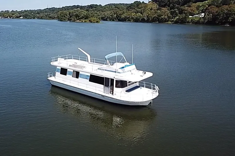 Slide: The Image of 1977 Pluckebaum Baymaster 52 X 17 Sport Cruiser on serene lake waters. - 45