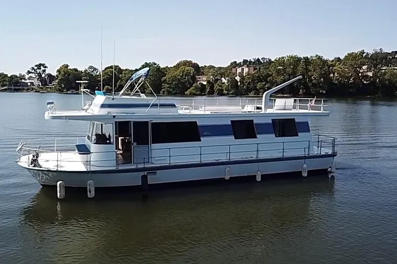 Slide: The Image of 1977 Pluckebaum Baymaster 52 X 17 Walkaround Sport Cruiser on a serene lake. - 48