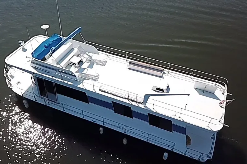 Slide: The Image of 1977 Pluckebaum Baymaster 52 X 17 Walkaround Sport Cruiser on calm water. - 50