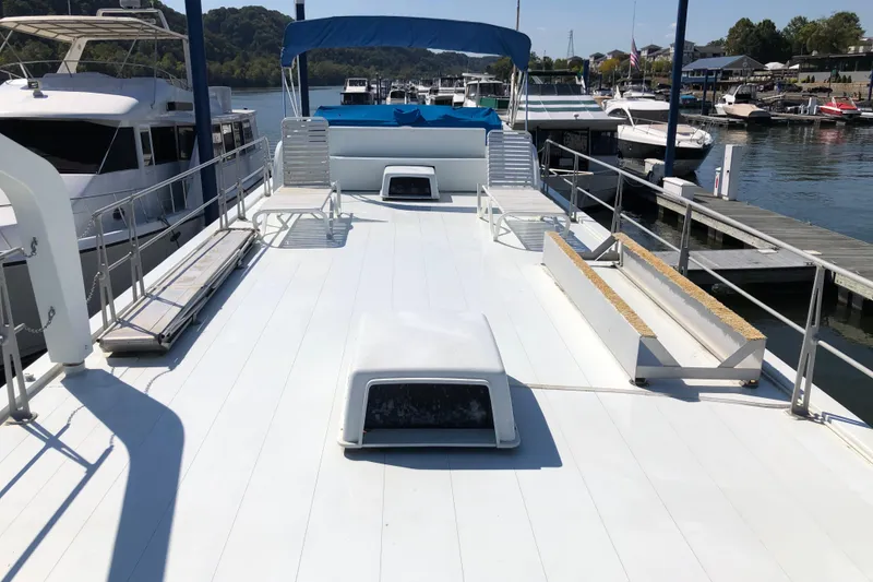 Slide: The Image of 1977 Pluckebaum Baymaster 52 yacht deck with seating, docked at marina. - 6