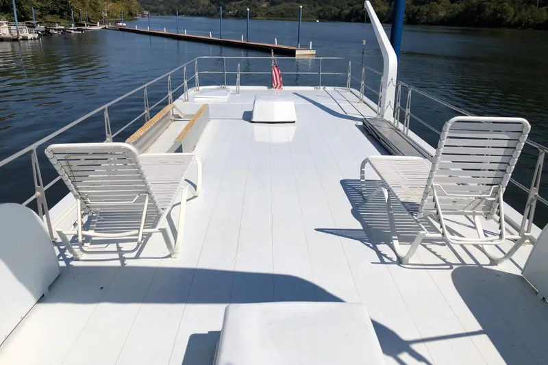 Slide: The Image of 1977 Pluckebaum Baymaster 52 yacht deck with lounge chairs and scenic water view. - 8
