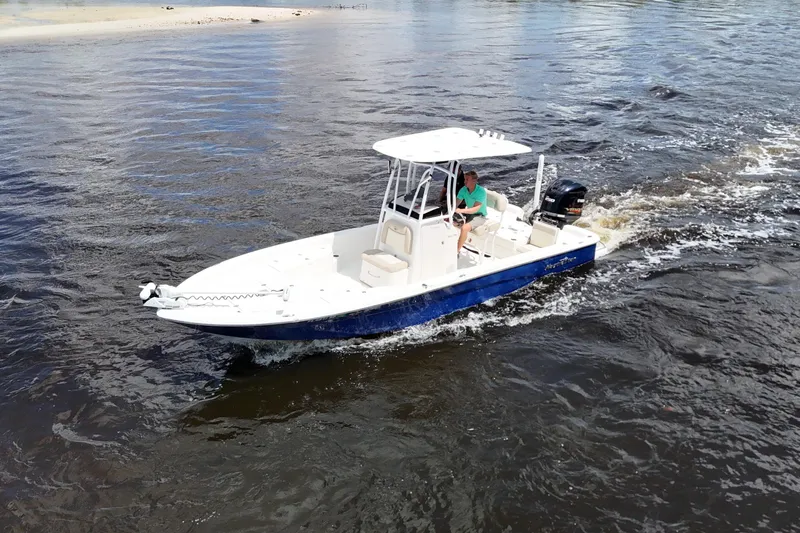 The Image of 2017 NauticStar 244 XTS boat cruising on open water, featuring a sleek design. - 0
