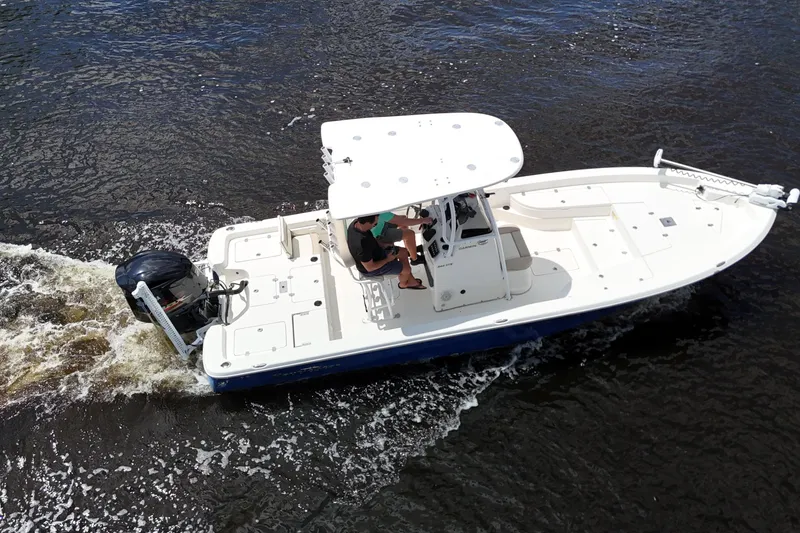 Slide: The Image of 2017 NauticStar 244 XTS boat cruising on water, aerial view. - 14
