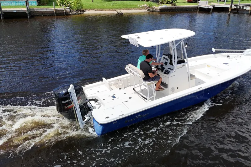 Slide: The Image of 2017 NauticStar 244 XTS boat cruising on a calm waterway. - 18