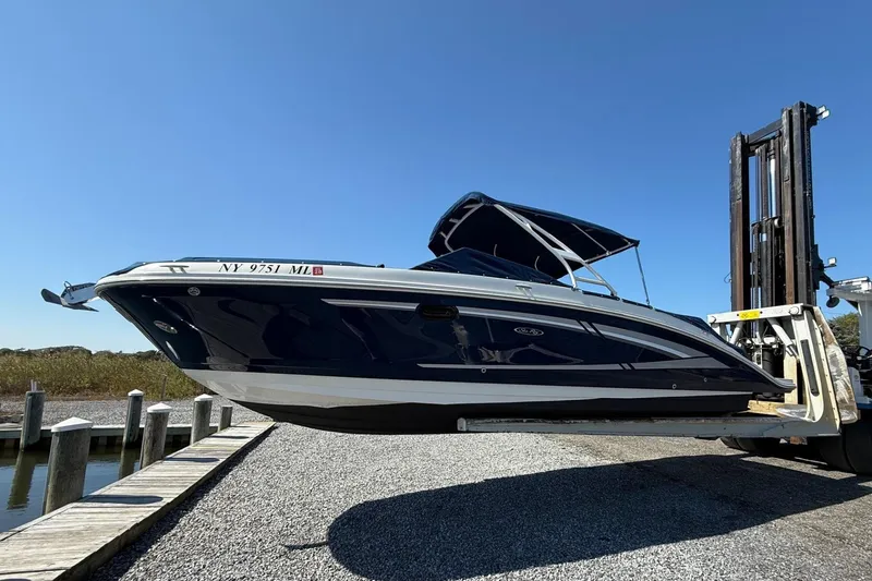 Slide: The Image of 2016 Sea Ray 270 Sundeck boat lifted by forklift at marina. - 1
