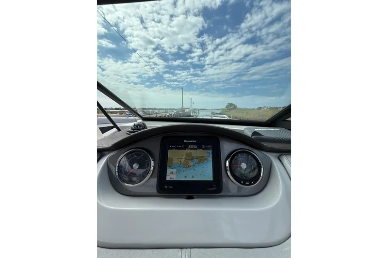 Slide: The Image of Dashboard view of 2016 Sea Ray 270 Sundeck with navigation display and gauges. - 10