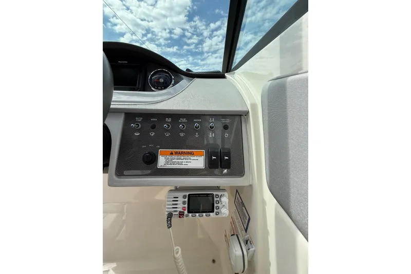 Slide: The Image of Control panel of a 2016 Sea Ray 270 Sundeck boat under a blue sky. - 11