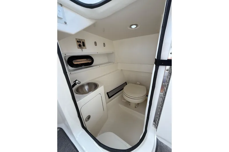 Slide: The Image of Interior of 2016 Sea Ray 270 Sundeck boat bathroom with sink and toilet. - 12