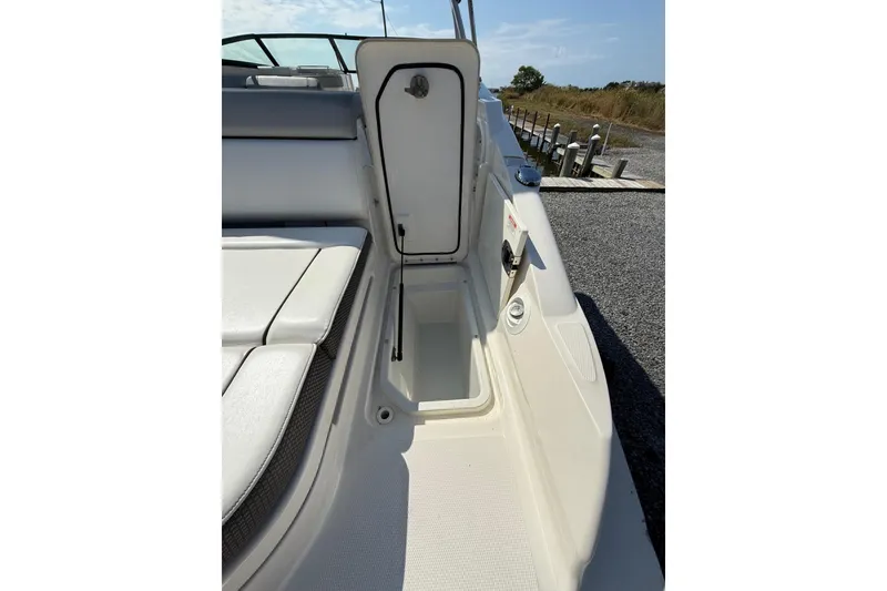 Slide: The Image of 2016 Sea Ray 270 Sundeck interior with open storage compartment and seating. - 18
